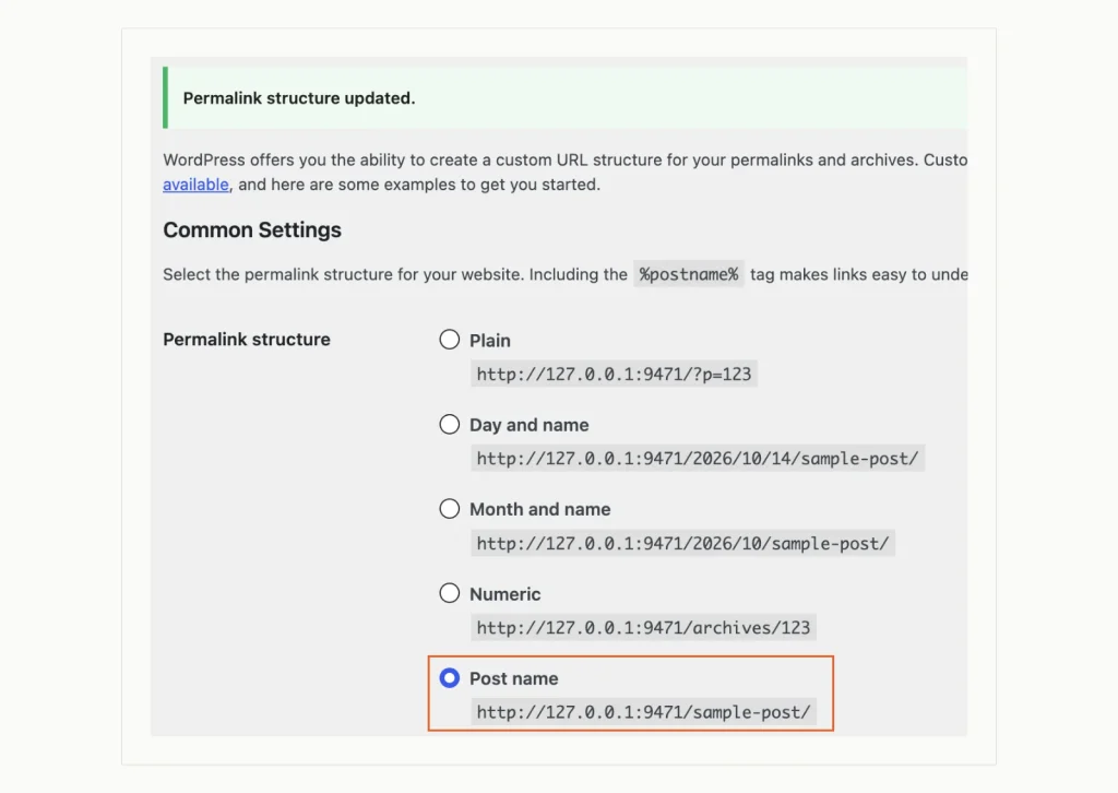 WordPress Permalink Settings with the message Permalink structure updated and the Post name option selected, below the Plain, Day and name, Month and name and Numeric options.